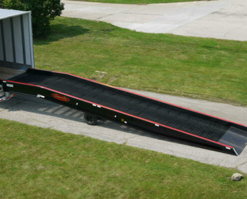 Copperloy single acting hydraulic ramp linked to a truck trailer.